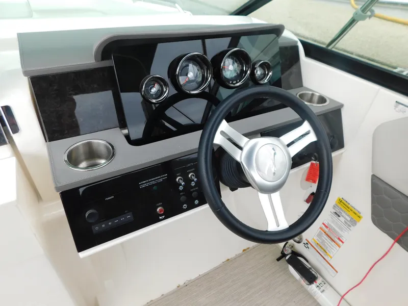 Slide: The Image of 2021 Sea Ray SDX 250 dashboard with steering wheel and control panel. - 11