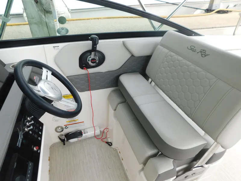 Slide: The Image of 2021 Sea Ray SDX 250 boat interior with steering wheel and seating. - 12