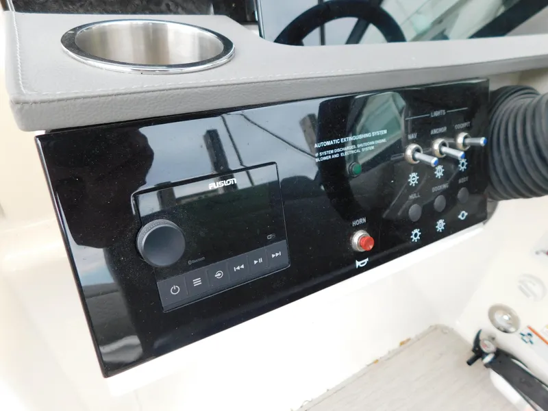 Slide: The Image of Control panel of a 2021 Sea Ray SDX 250 boat with audio system and switches. - 13