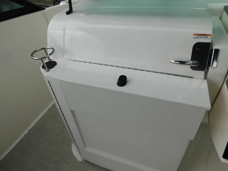 Slide: The Image of 2021 Sea Ray SDX 250 boat interior detail with cup holder and storage compartment. - 15