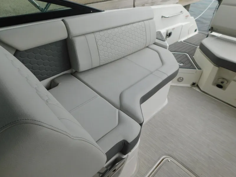 Slide: The Image of 2021 Sea Ray SDX 250 boat interior with gray cushioned seating. - 16
