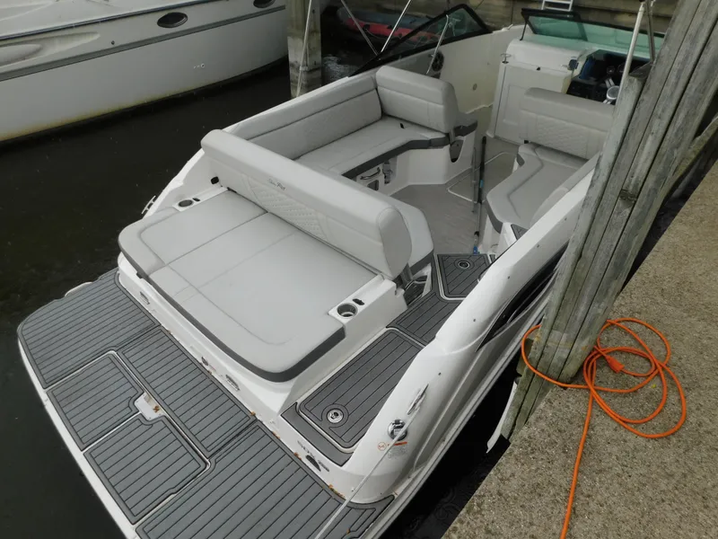 Slide: The Image of 2021 Sea Ray SDX 250 boat with spacious seating and sleek design docked at marina. - 3
