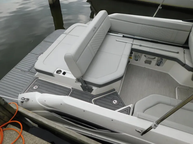 Slide: The Image of 2021 Sea Ray SDX 250 boat interior with gray seating and deck, docked by water. - 4