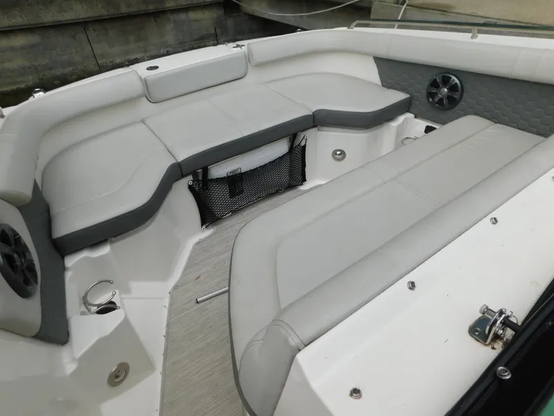 Slide: The Image of Interior seating of a 2021 Sea Ray SDX 250 boat, featuring gray upholstery and speakers. - 5