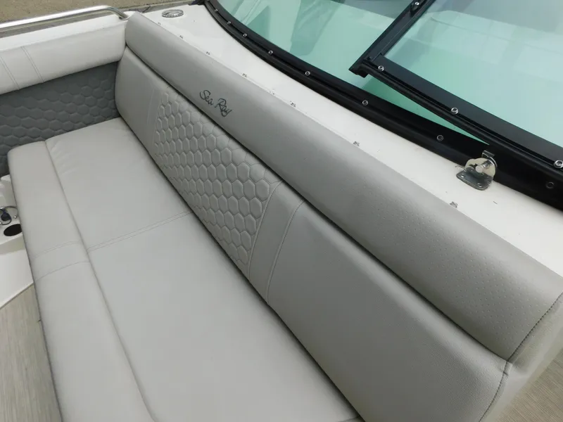 Slide: The Image of 2021 Sea Ray SDX 250 boat interior with gray cushioned seating and hexagonal pattern. - 6