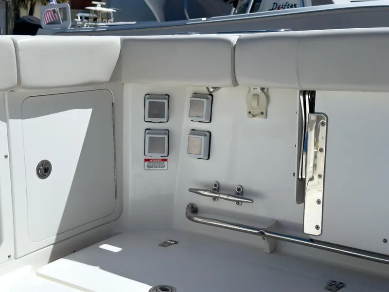 Slide: The Image of 2018 Boston Whaler 315 Conquest boat interior, featuring control panel and seating area. - 20