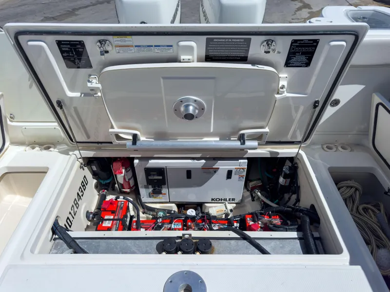 Slide: The Image of Engine compartment of 2018 Boston Whaler 315 Conquest with Kohler generator and batteries. - 22