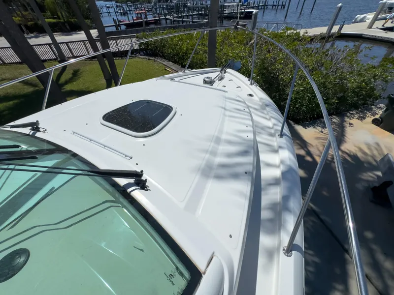 Slide: The Image of 2018 Boston Whaler 315 Conquest boat deck with railing, docked near waterfront. - 40