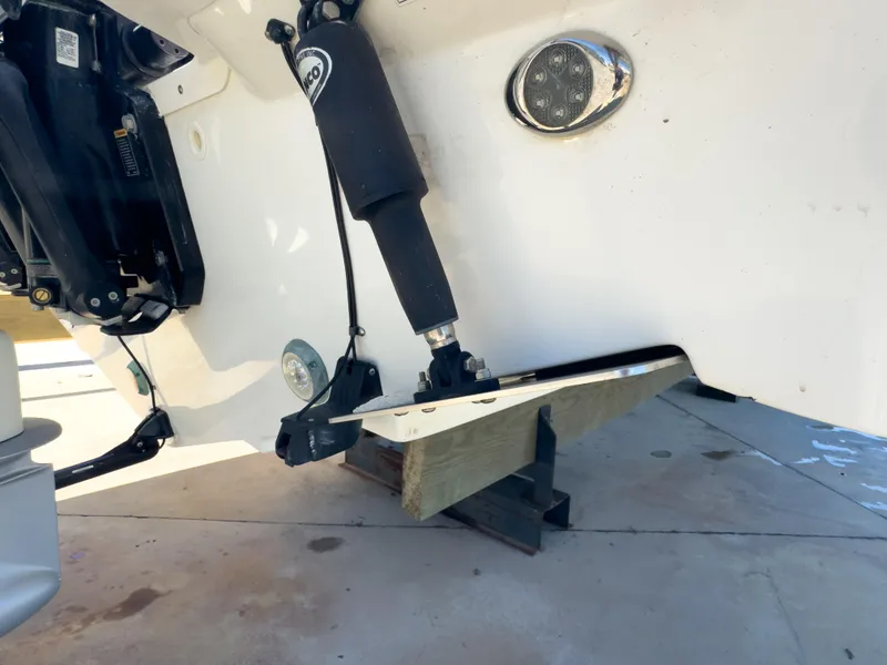 Slide: The Image of 2018 Boston Whaler 315 Conquest boat engine and trim tab detail. - 9