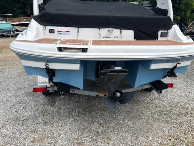 Slide: The Image of 2018 Regal 2000 ES Bowrider boat, rear view, on a trailer, with covered deck. - 3