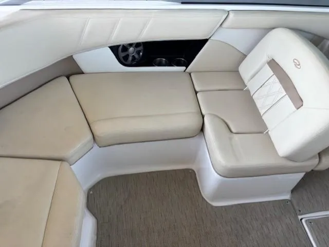 Slide: The Image of 2018 Regal 2000 ES Bowrider interior with beige seating and carpeted flooring. - 7