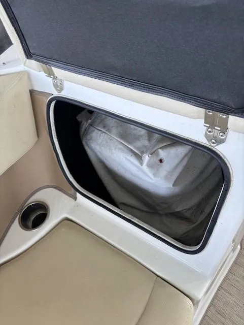 Slide: The Image of Storage compartment in 2018 Regal 2000 ES Bowrider boat, open with visible contents. - 9