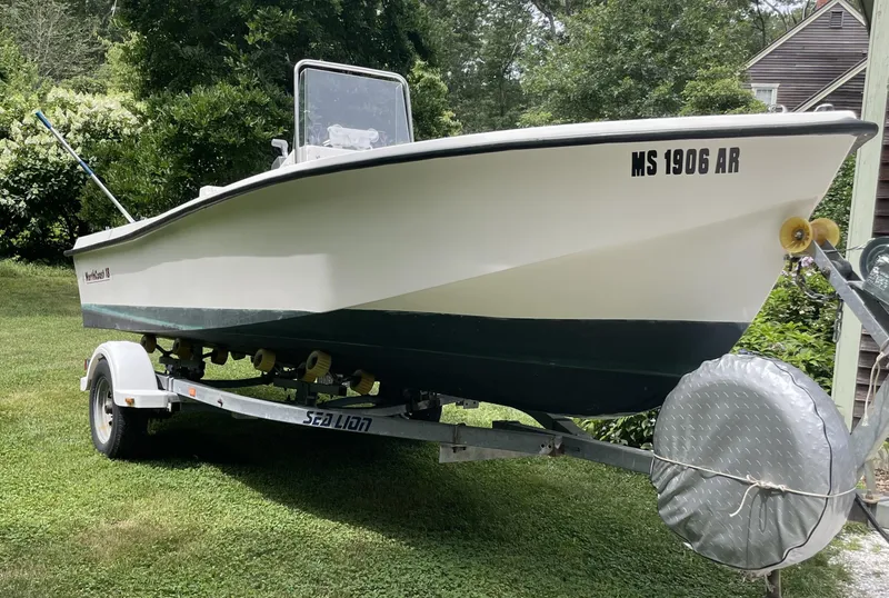 The Image of 2006 NorthCoast 180 Center Console boat on trailer, parked on grass. - 0