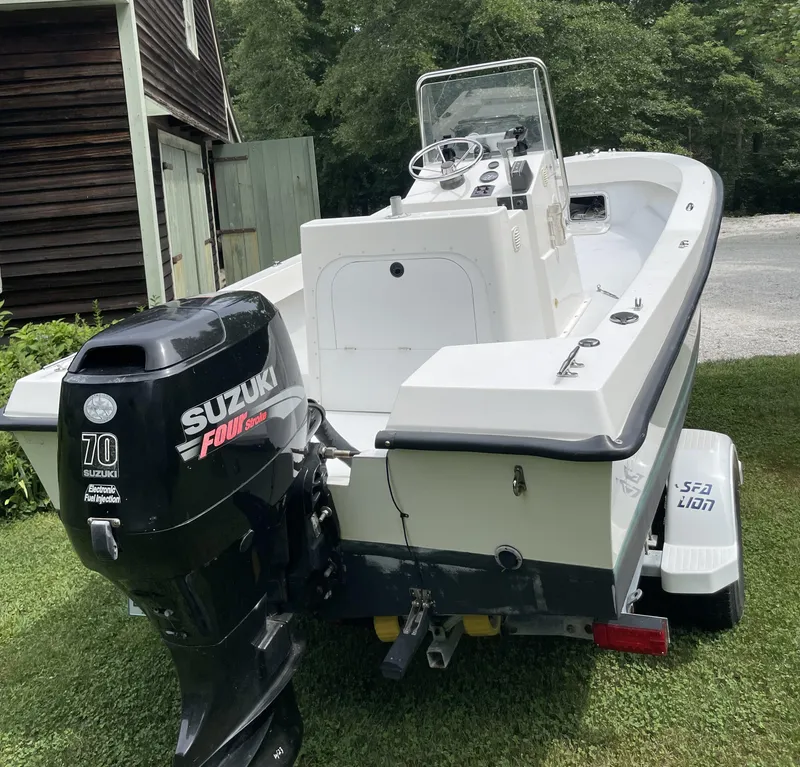 Slide: The Image of 2006 NorthCoast 180 Center Console boat with Suzuki 70HP outboard motor on trailer. - 2