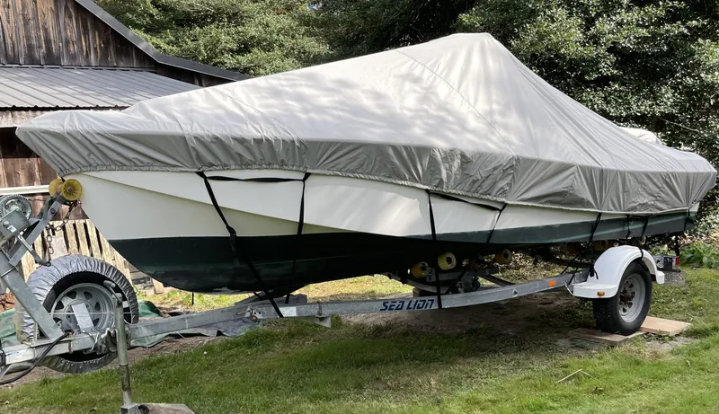 Slide: The Image of 2006 NorthCoast 180 Center Console boat covered on trailer, parked outdoors. - 8