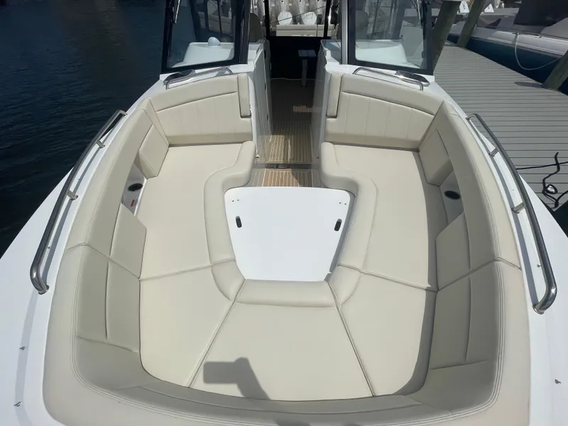 Slide: The Image of 2025 MJM 3 boat with spacious, cushioned seating area and sleek design. - 11