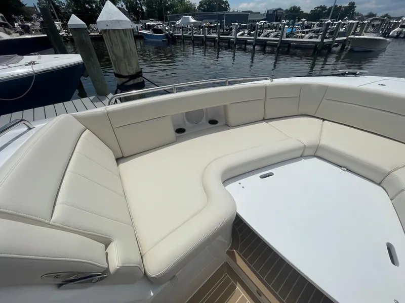 Slide: The Image of Luxurious seating area on the 2025 MJM 3 boat docked at a marina. - 12