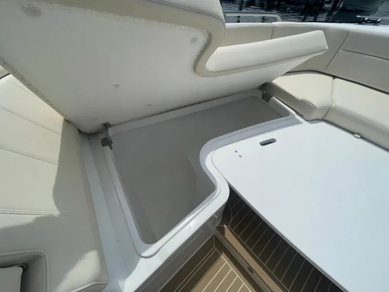 Slide: The Image of Storage compartment in the 2025 MJM 3 boat with cushioned seating. - 14