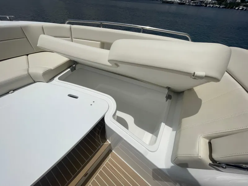 Slide: The Image of 2025 MJM 3 boat with white cushioned seating and storage compartment. - 15