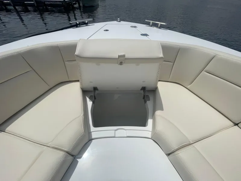 Slide: The Image of 2025 MJM 3 boat with open storage compartment and cushioned seating. - 16