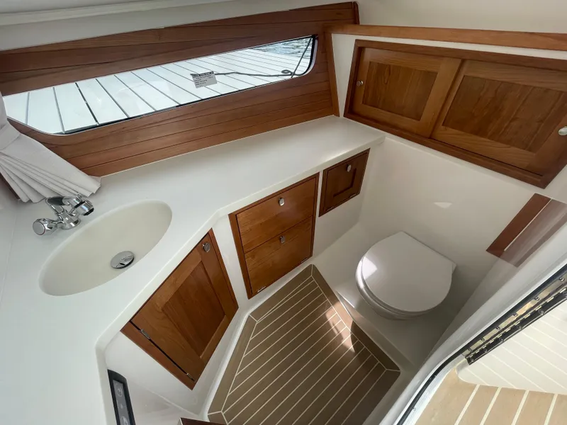 Slide: The Image of Modern bathroom in MJM 3 boat, 2025 model, featuring wooden cabinets and sleek fixtures. - 21