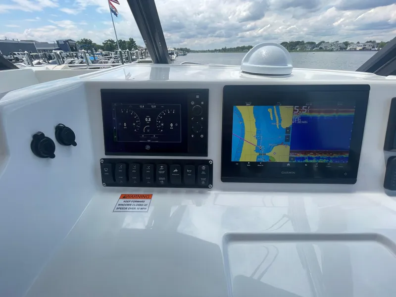 Slide: The Image of MJM 3 2025 boat dashboard with navigation and control screens. - 25