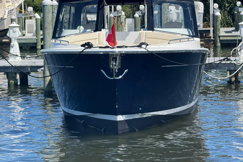 Slide: The Image of Front view of a 2025 MJM 3 boat docked in a marina. - 3