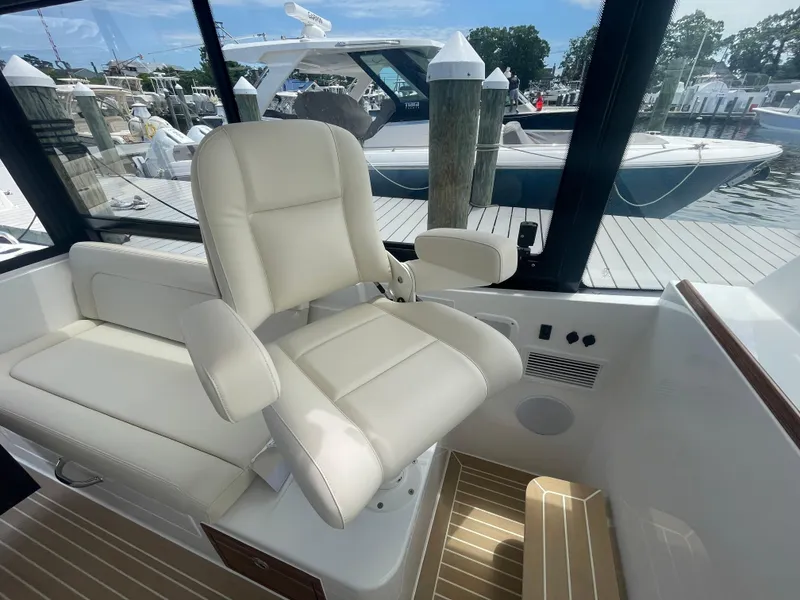 Slide: The Image of Luxury captain's chair on MJM 3 boat, 2025 model, docked at marina. - 30
