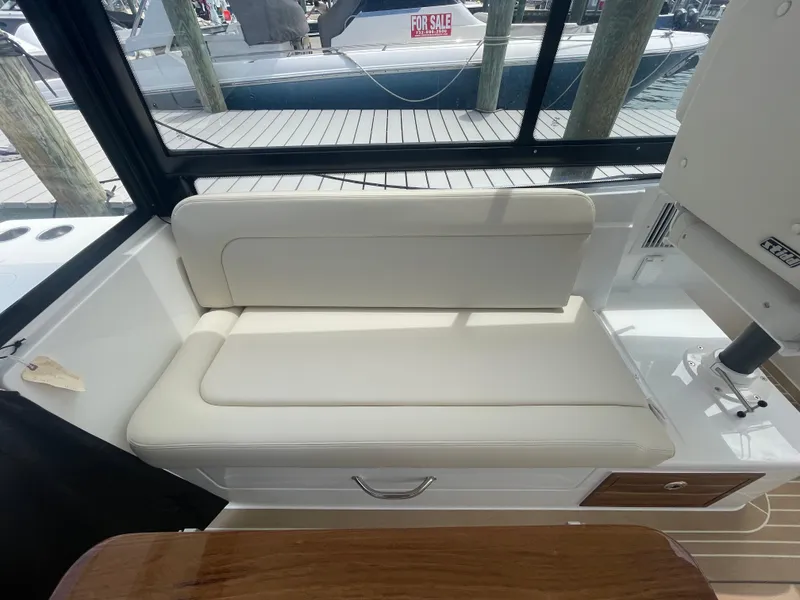 Slide: The Image of Interior seating of 2025 MJM 3 boat with white cushions and wooden accents. - 35