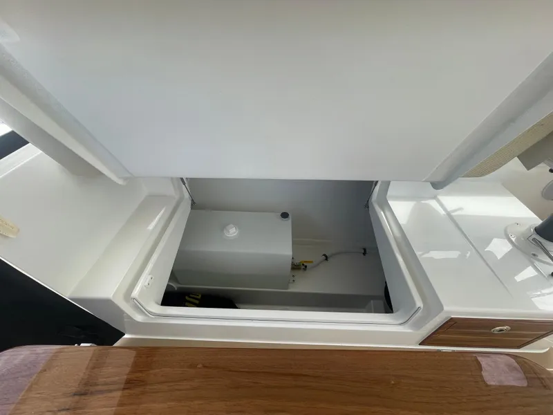 Slide: The Image of 2025 MJM 3 boat interior storage compartment with white and wooden finishes. - 36