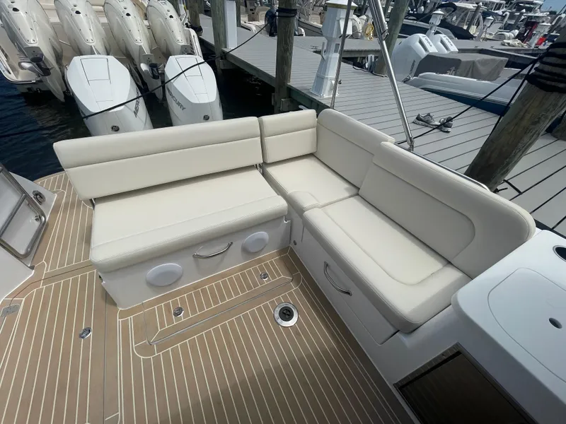 Slide: The Image of 2025 MJM 3 boat with beige leather seating and teak deck at a marina. - 39