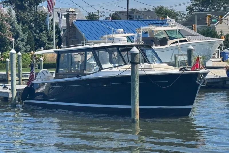 Slide: The Image of 2025 MJM 3 boat docked at marina, featuring sleek design and modern amenities. - 4