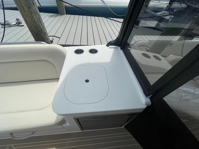 Slide: The Image of MJM 3 2025 boat interior with white seating and countertop. - 42