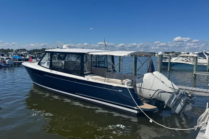 Slide: The Image of 2025 MJM 3 boat docked at marina under clear blue sky. - 6