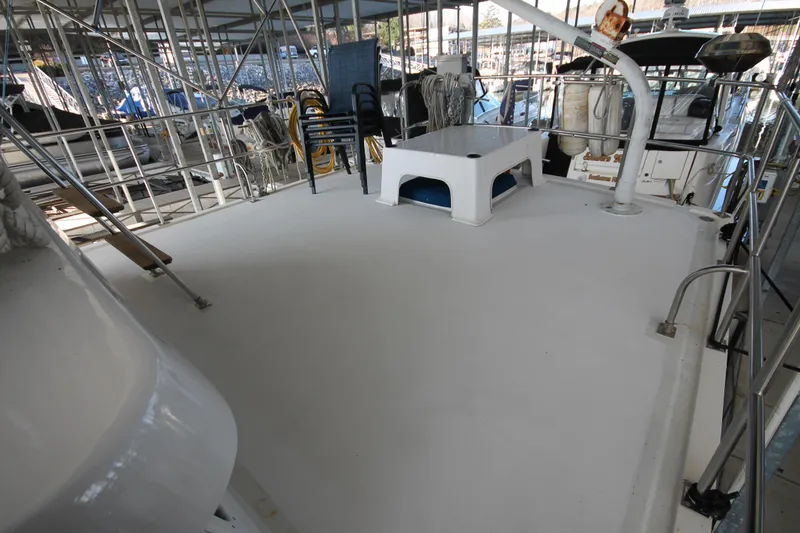 Slide: The Image of 1986 Senator 35 Sundeck Trawler with spacious deck, docked in marina. - 11