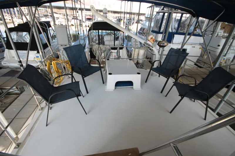 Slide: The Image of 1986 Senator 35 Sundeck Trawler with outdoor seating and table on deck. - 12