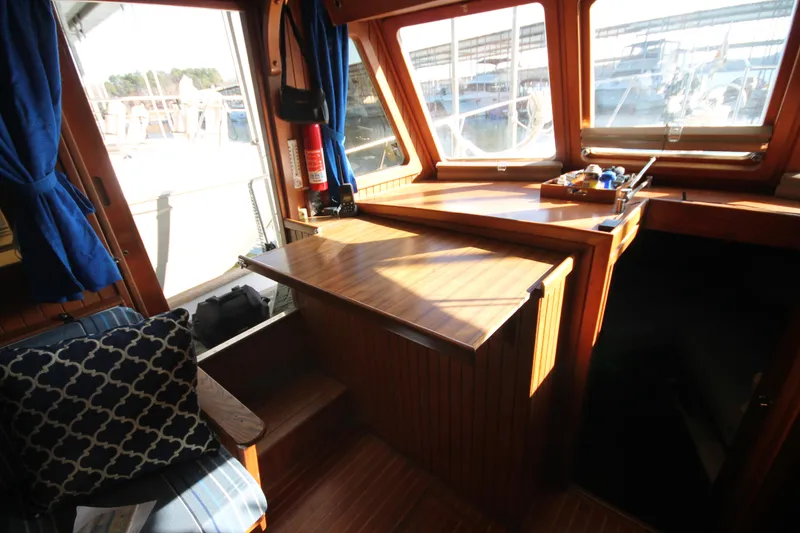 Slide: The Image of 1986 Senator 35 Sundeck Trawler interior with wooden finish and nautical decor. - 23