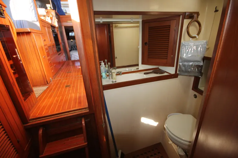 Slide: The Image of 1986 Senator 35 Sundeck Trawler bathroom with wooden interior and compact design. - 25