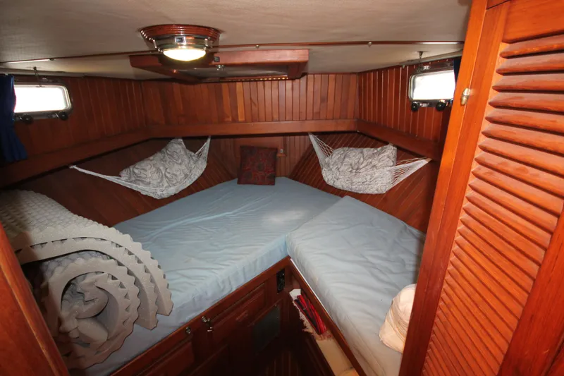 Slide: The Image of Cozy cabin interior of 1986 Senator 35 Sundeck Trawler with wooden paneling and bedding. - 26