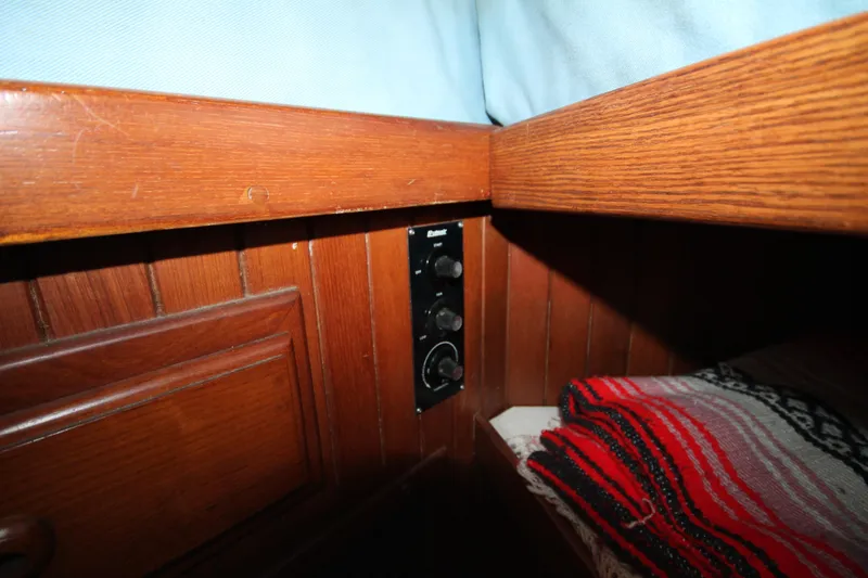 Slide: The Image of 1986 Senator 35 Sundeck Trawler interior with wood paneling and control panel. - 27