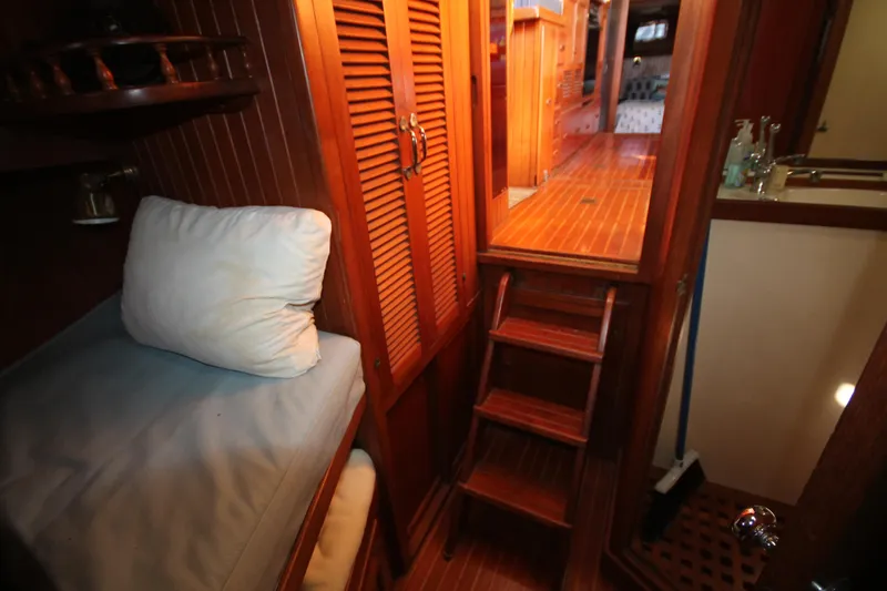 Slide: The Image of Cozy cabin interior of 1986 Senator 35 Sundeck Trawler with wooden finishes and bedding. - 28