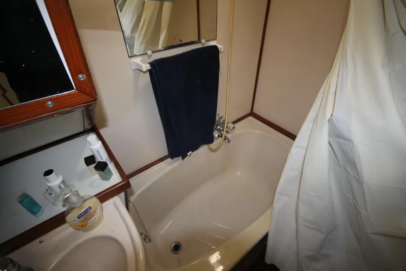 Slide: The Image of Bathroom interior of 1986 Senator 35 Sundeck Trawler with bathtub and mirror. - 32