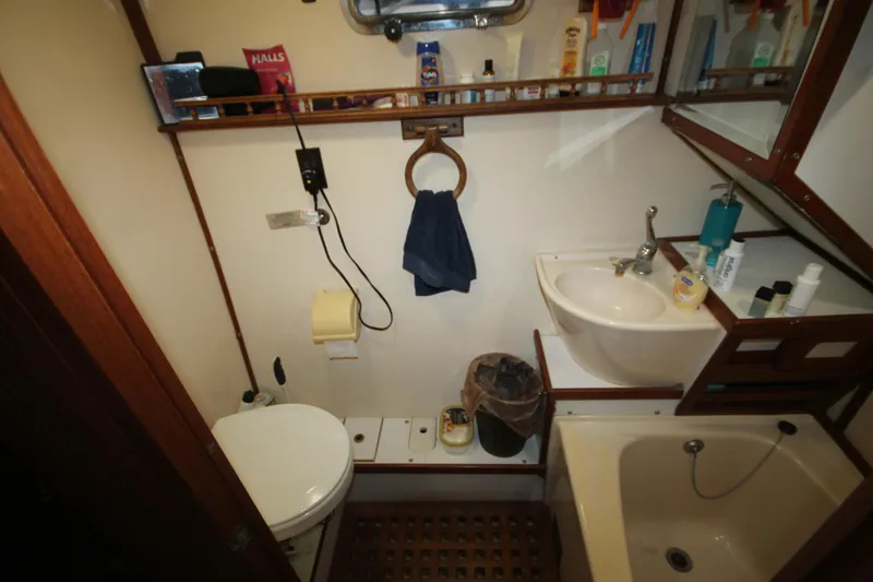 Slide: The Image of Bathroom interior of 1986 Senator 35 Sundeck Trawler with sink, toilet, and toiletries. - 34