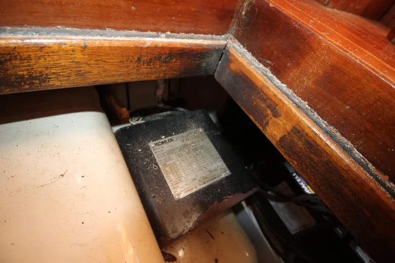 Slide: The Image of 1986 Senator 35 Sundeck Trawler interior showing engine compartment with visible wear. - 38
