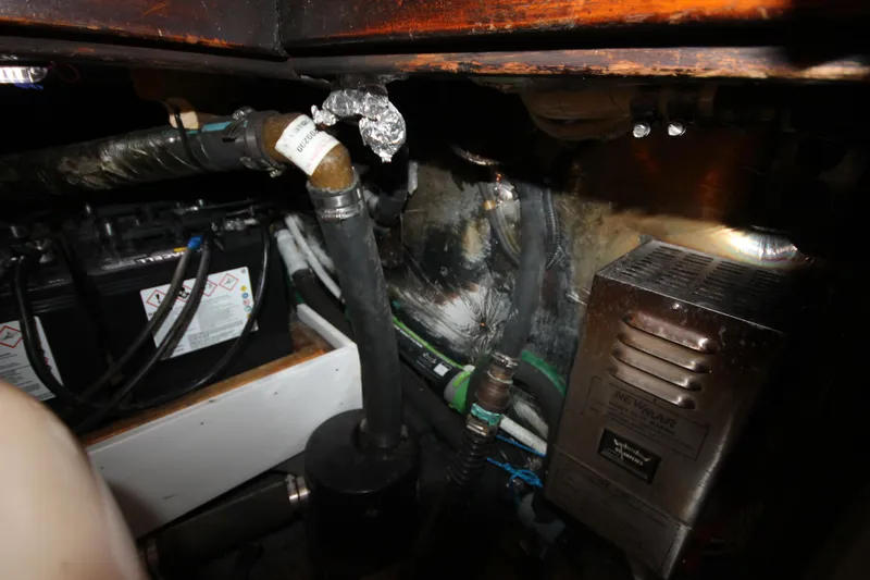 Slide: The Image of Engine compartment of 1986 Senator 35 Sundeck Trawler with battery and wiring. - 42