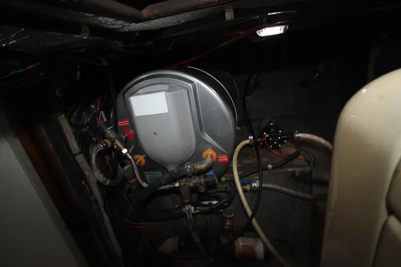Slide: The Image of Engine room of a 1986 Senator 35 Sundeck Trawler, showcasing mechanical components and wiring. - 43