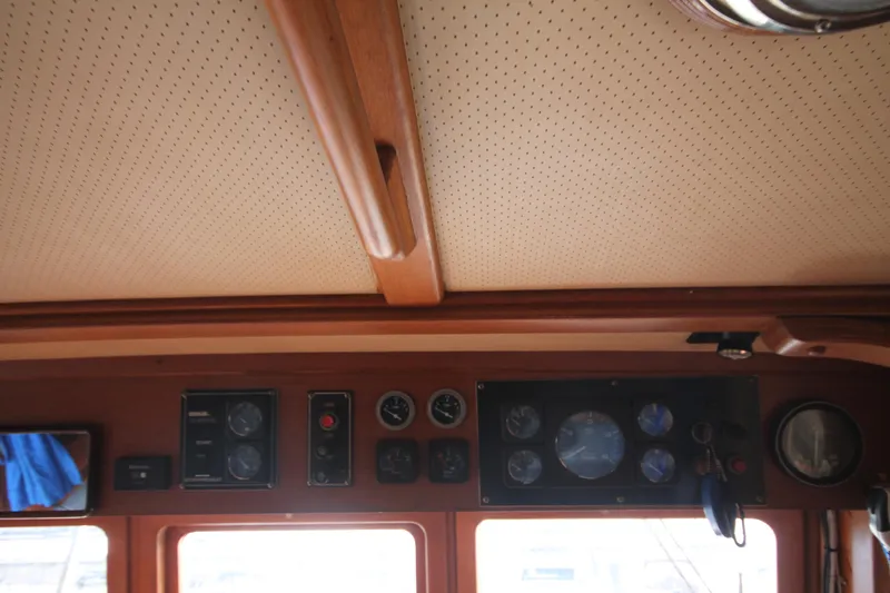 Slide: The Image of 1986 Senator 35 Sundeck Trawler dashboard with gauges and controls. - 45