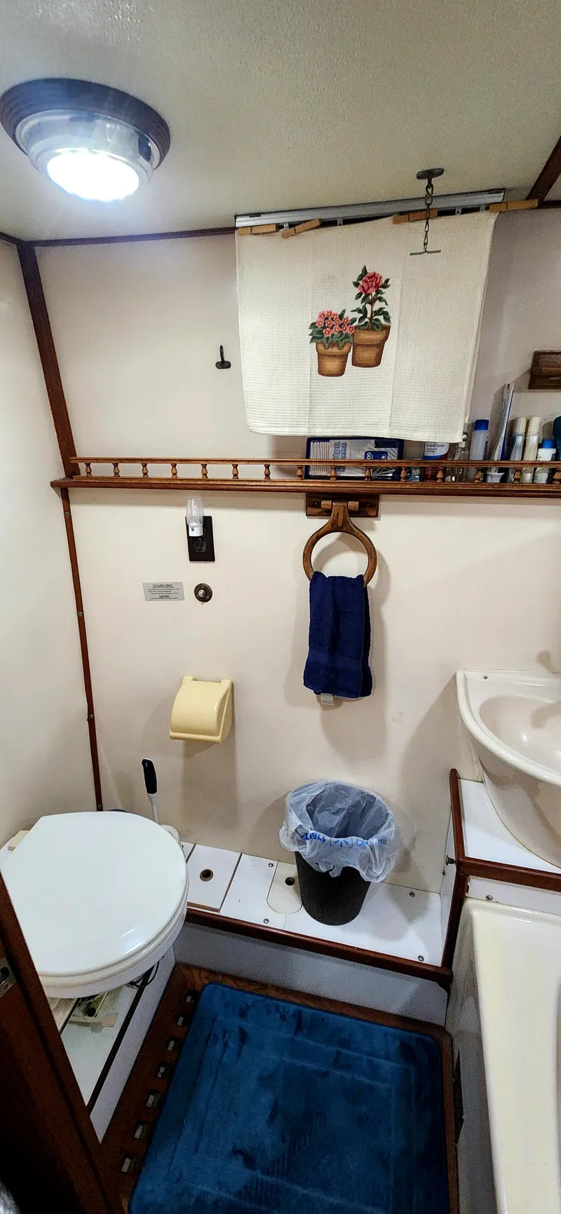 Slide: The Image of Bathroom interior of a 1986 Senator 35 Sundeck Trawler, featuring toilet, sink, and nautical decor. - 47