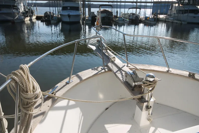 Slide: The Image of 1986 Senator 35 Sundeck Trawler at marina, showcasing bow and anchor details. - 9