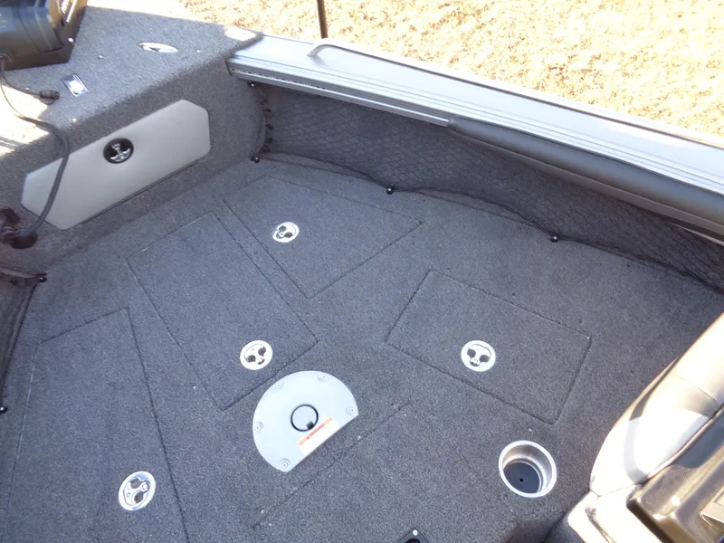 Slide: The Image of 2025 Lund 1875 Tyee boat interior with carpeted deck and storage compartments. - 10